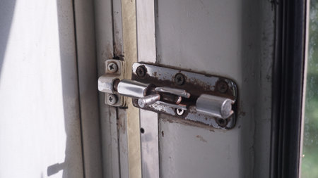 Close-up of an old lock on the door of a houseの写真素材