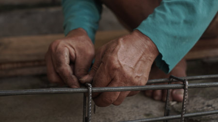 Close-up of the hands of an old man working on a construction siteの写真素材