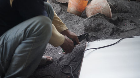 Close-up of the hands of an electrician working on the construction siteの写真素材