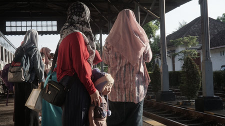 Muslim women wait for the train in Faro, Portugal.の写真素材