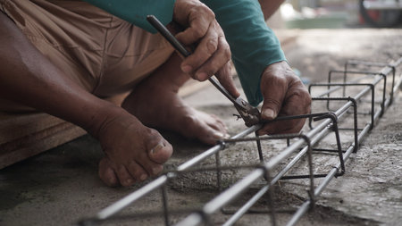Close up of an old man working on a construction site in Thailandの写真素材