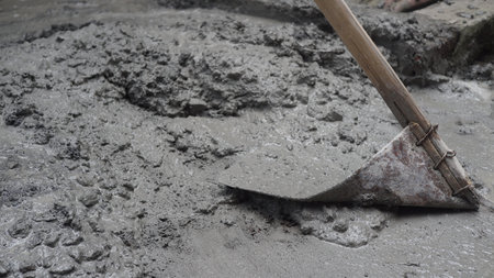 Shovel on a cement floor in a construction site. Close-up.の写真素材