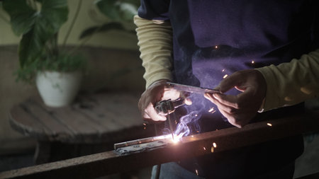 Close-up of a welder using a welding torch to weld metalの写真素材