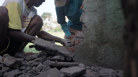 Workers are building a brick wall at a construction site in Sri Lankaの写真素材