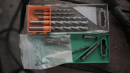 Drill bits and drill bits in a tool box on a workbenchの写真素材