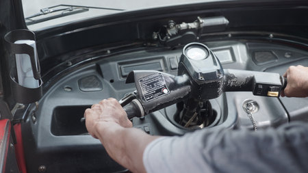 Closeup of a man's hand holding a steering wheel of a carの写真素材