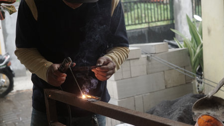 Welding work in the workshop. The welder welds metal.の写真素材