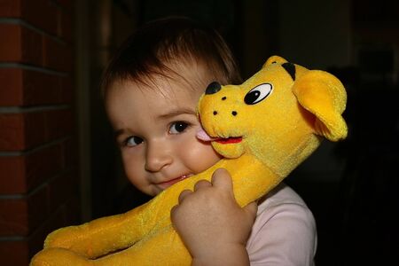 my daughter with a puppy toyの写真素材