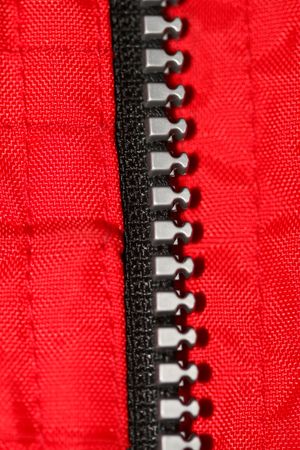 Closeup shot of plastic zipper on the red sweater.の写真素材