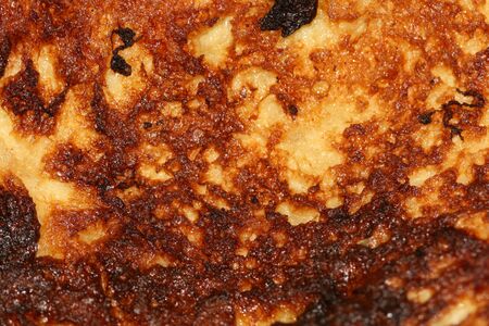 Closeup shot of surface of roasted bread in milk and eggs.