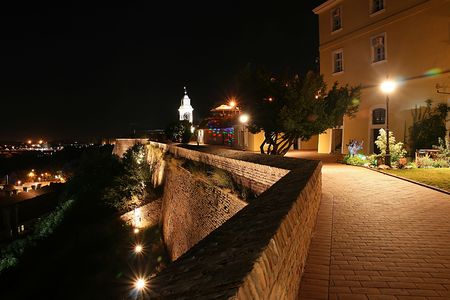 The walls of Petrovaradin fortress, promenade and old clock tower, by night, this is a place of Exit festival in Serbiaの写真素材