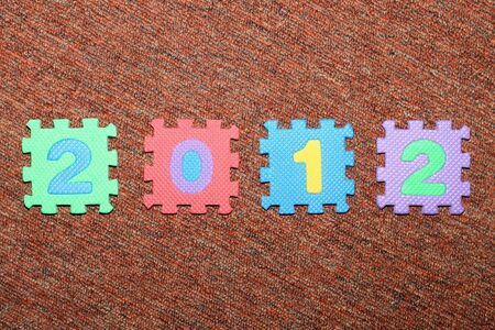 Year 2012 on the carpet, from colorful letter-puzzle.
