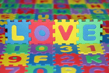 This is a background from colorful letter-puzzle, with word Love in the middle.の写真素材
