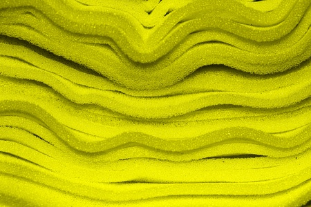layers of yellow sponge as interesting backgrounの写真素材