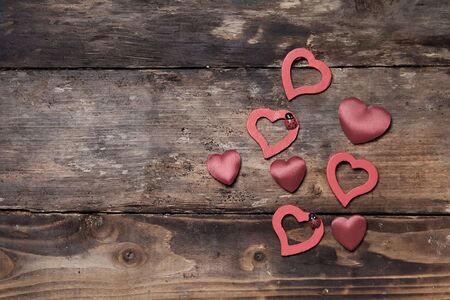 Red hearts on the wooden boardsの写真素材
