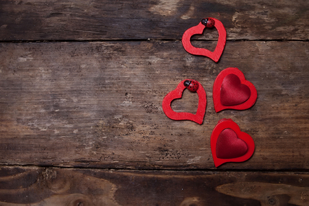 Red hearts on the wooden boardの写真素材