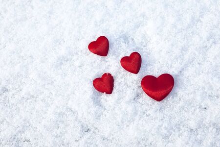 Red hearts on the snowの写真素材