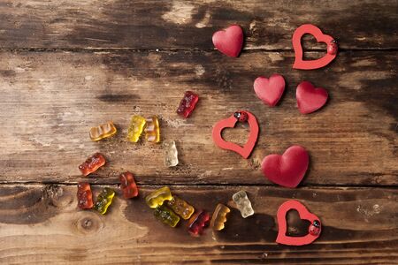 Red hearts and candies on the wood boardの写真素材