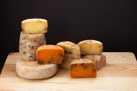 A different kinds of cheese on a wooden tableの写真素材
