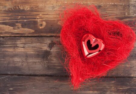 Red heart on the wooden tableの写真素材