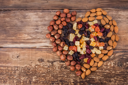 Different kinds of nuts and dried fruits in the shape of heartの写真素材