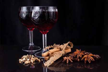 Two wineglasses of wine and different kinds of flavoringの写真素材