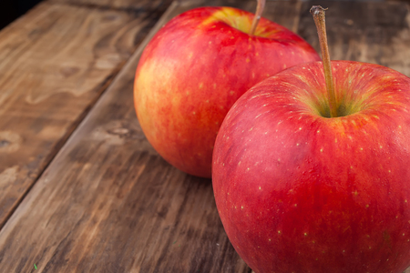 Red apples on a dark wooden tableの写真素材