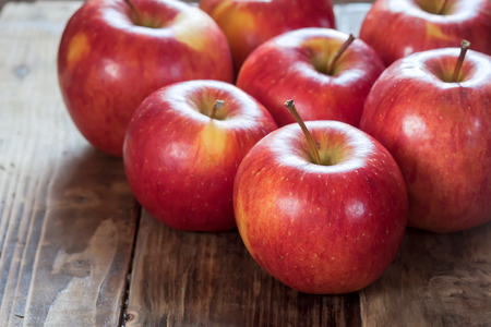 Red apples on a dark wooden tableの写真素材