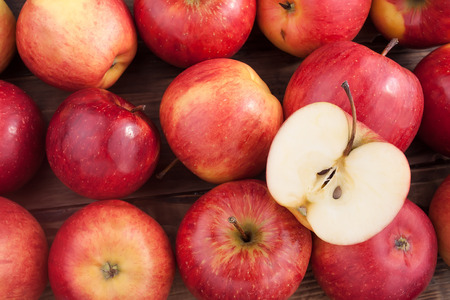 Red apples on a dark wooden tableの写真素材