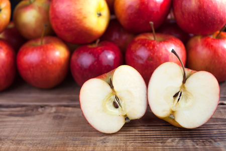 Red apples on a dark wooden tableの写真素材