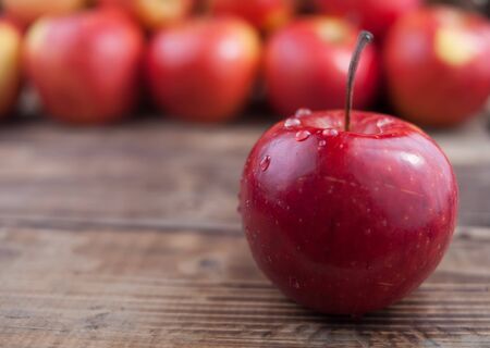 Red apples on a dark wooden tableの写真素材