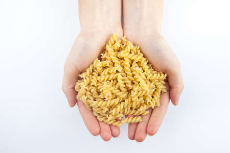 pasta in hands on white background isolatedの写真素材