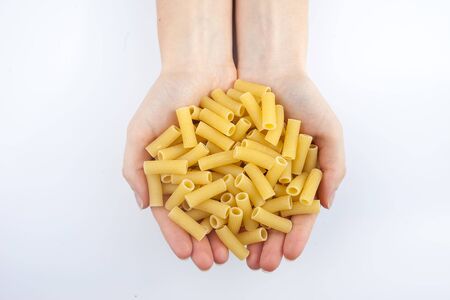 pasta in hands on white background isolatedの写真素材