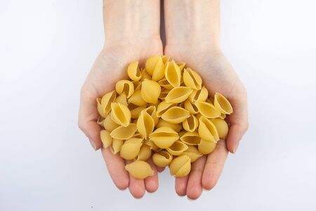 pasta in hands on white background isolatedの写真素材