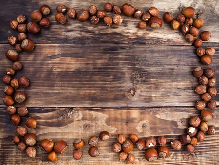 A hazelnuts on the dark wooden tableの写真素材