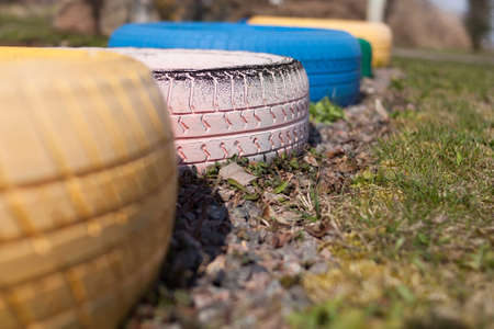 colored tires on a grass in the gardenの写真素材