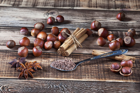 Nuts, chocolate and different spices on wooden tableの写真素材