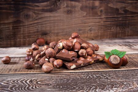 nuts and chocolate on a wooden tableの写真素材