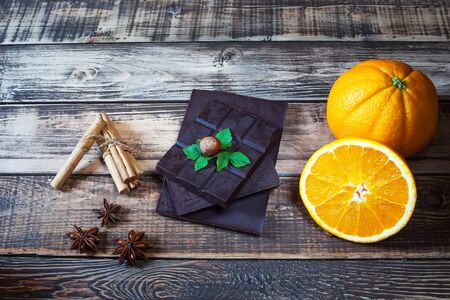 nuts, orange, chocolate and different spices on wooden tableの写真素材