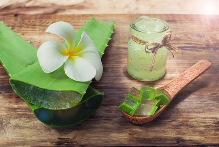 Aloe vera gel and Aloe leaf cut pieces on a wooden backgroundの写真素材