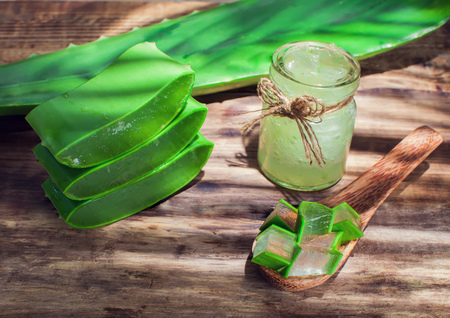 Aloe vera gel and Aloe leaf cut pieces on a wooden backgroundの写真素材