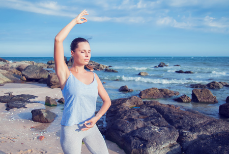 woman doing yoga on the beachの写真素材