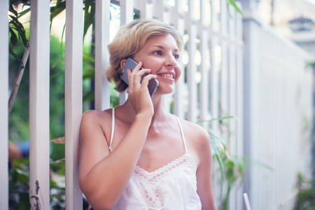 Young Beautiful Woman Talking On Mobile Phone Outdoor.の写真素材