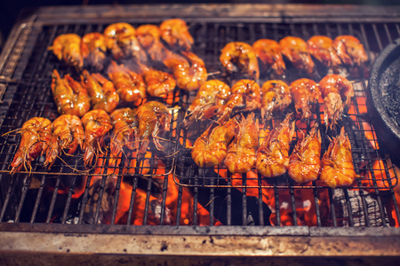 shrimps Seafood barbecue grilled on roaster and fireの写真素材