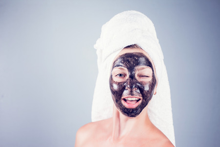 Close up shot of a beauty young woman using a black face maskの写真素材