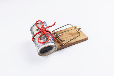 Many banknotes in mouse trap on the white background