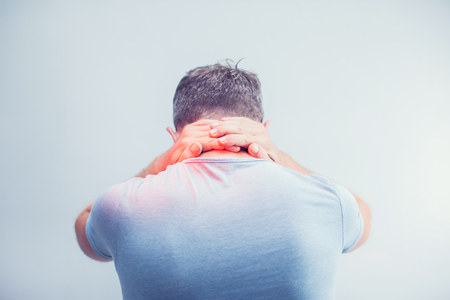 People, healthcare and problem concept - close up of man suffering from neck pain over gray backgroundの写真素材