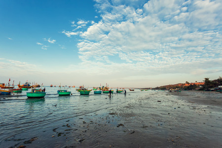 Traditional old wooden Vietnamese boats and round fishing boats in the seaの写真素材