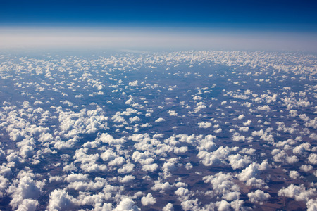 Beautiful view of cumulus clouds with sunny day atmosfera from airplain windowの写真素材