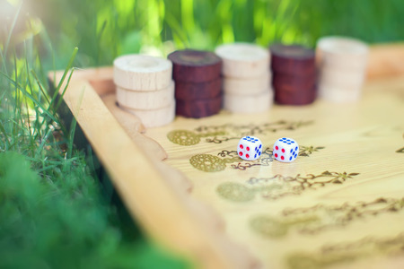 Color detail Backgammon game with two dice close up on the grass